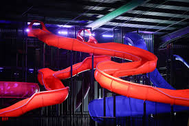 Indoor slide park with giant colourful slides at Slick City Nottingham