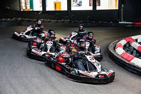 Electric indoor go-karts racing around the multi-level TeamSport Nottingham track