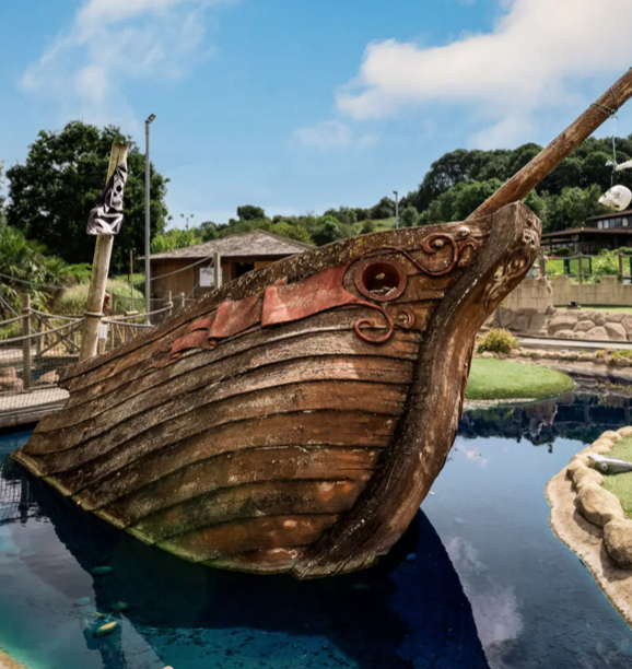 Pirate-themed crazy golf course with ship, waterfalls, and obstacles at Mr Mulligans